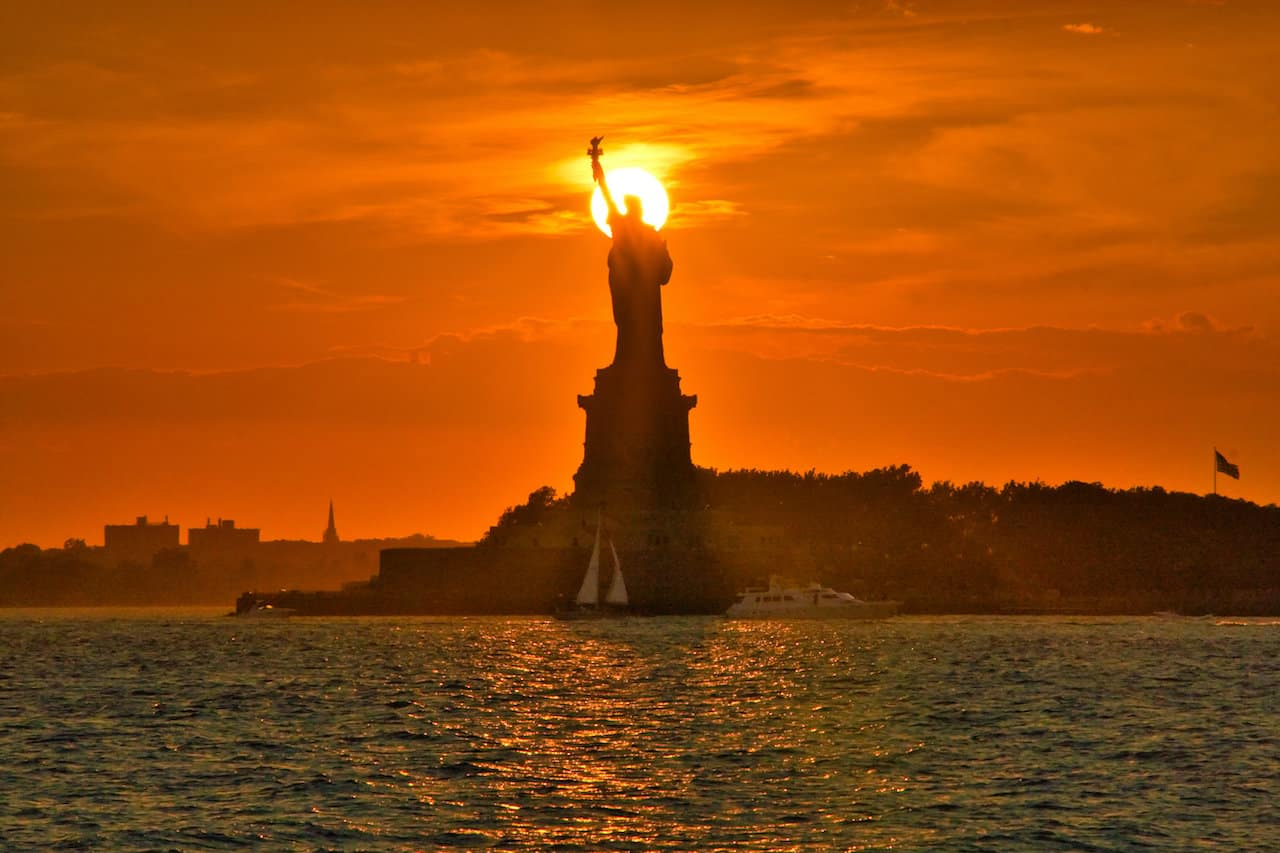 Sunsetting Behind Statue of Liberty